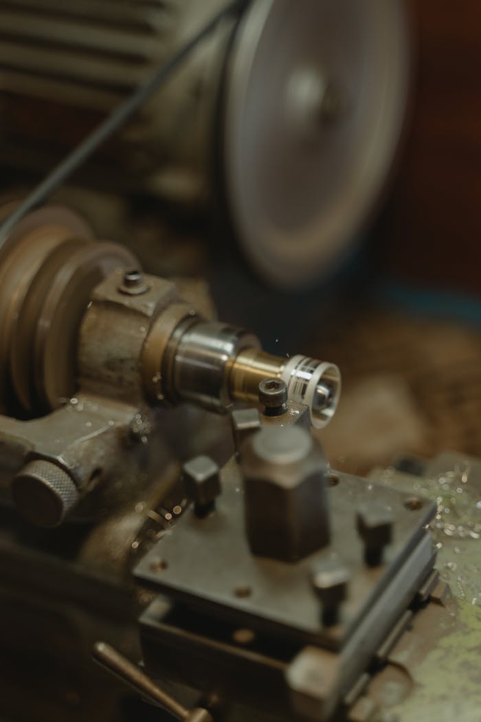 Detailed view of a metal lathe working in an industrial workshop environment.